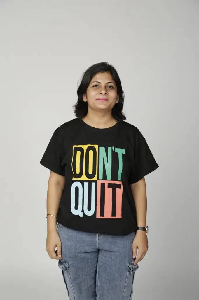 Woman looking straight wearing black branded t-shirt